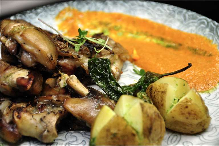 Manitas de cerdo a la brasa y con Romesco.